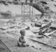 China: A terrified Chinese baby, one of the last humans left alive after intense bombing during the Japanese attack on Shanghai's South Station. August 1937.